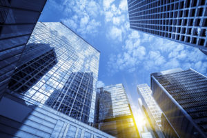 Skyscrapers reflecting a bright blue sky, symbolizing urban development and modern architecture