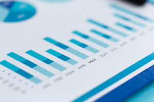 Close-up of a blue bar chart showing monthly data analysis and performance metrics.