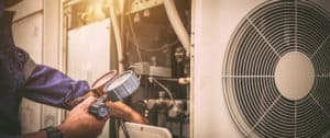 Technician performing maintenance on an HVAC unit, showcasing professional refrigerant management and system diagnostics