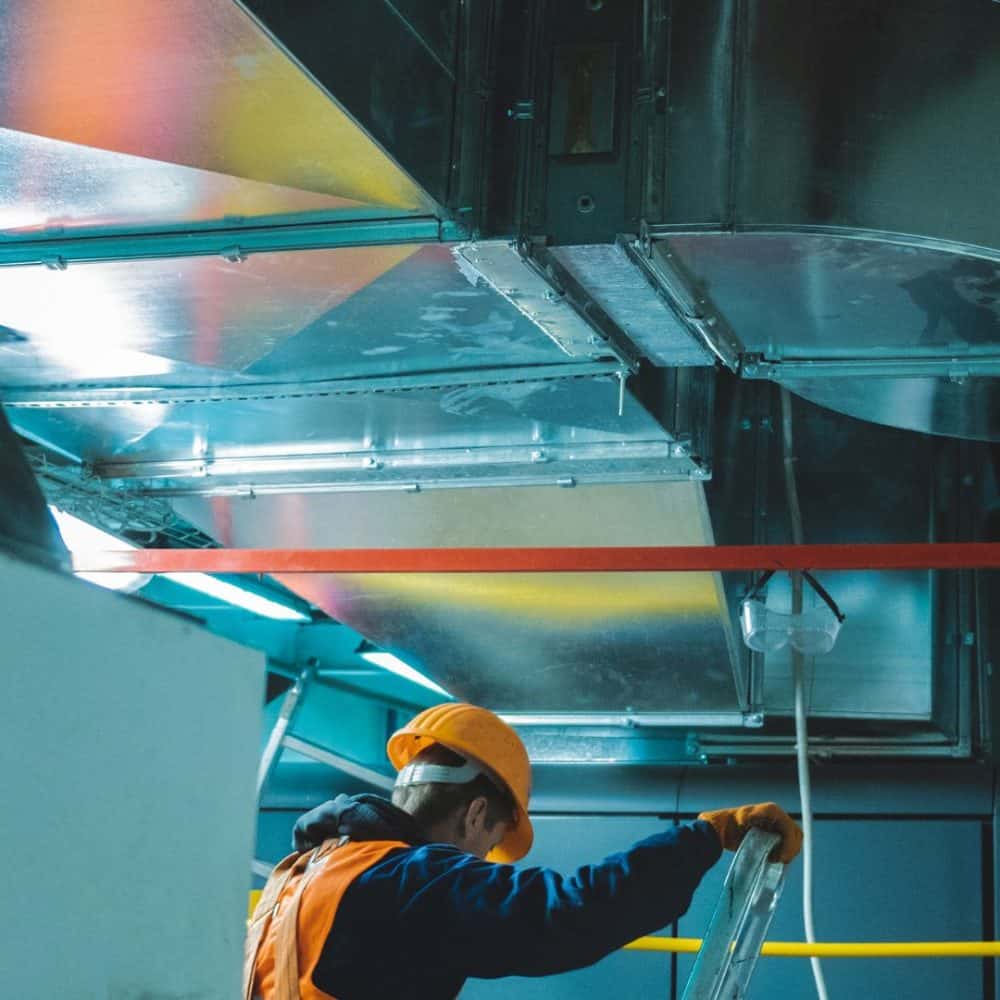 Technician working on a HVAC and EHS system