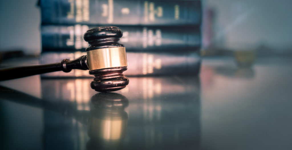 gavel on a table in front of law books